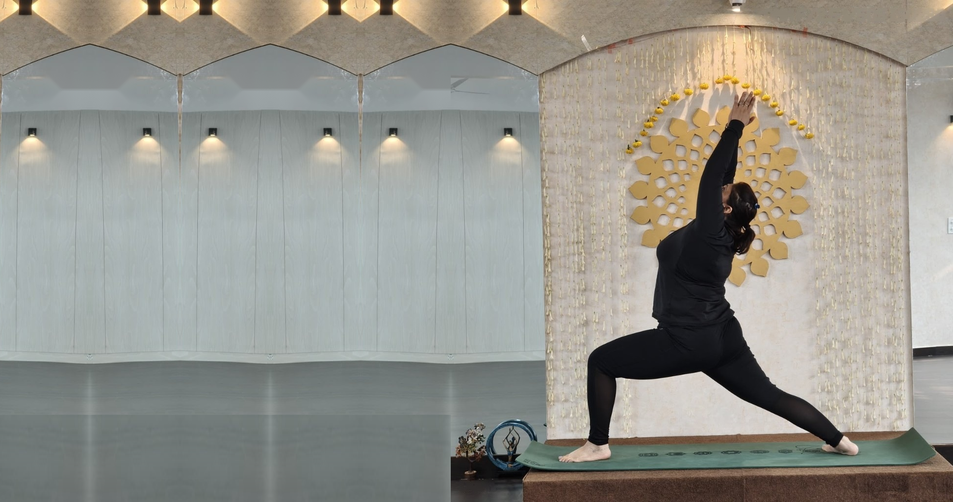A Vinyasa warrior pose in front of the gold mandala at the Zelosity studio